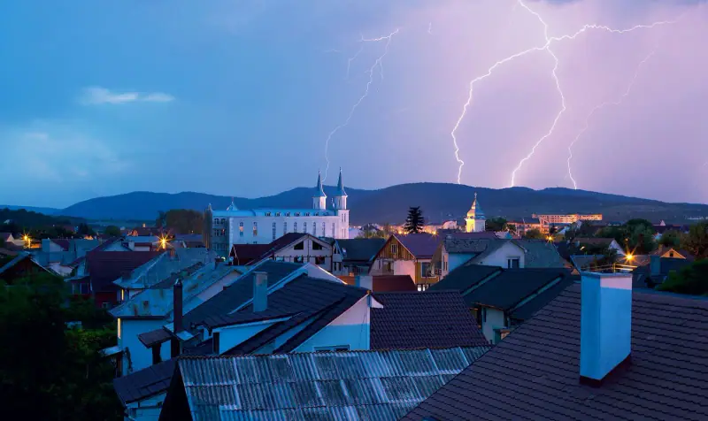 Lightning striking over a town at night