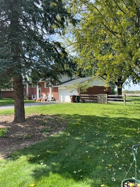 Brick home with new architectural shingle roof and ridge vent installed in Tipp City