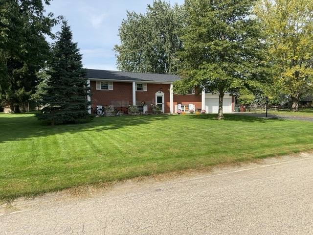 Front of brick home showing completed architectural asphalt shingle roof in Tipp City